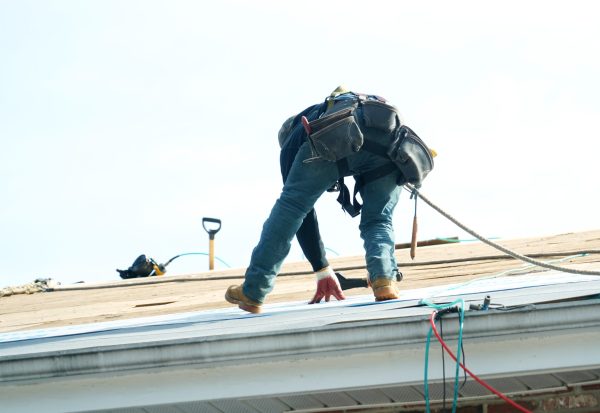Handyman working on repairing the roof roofing company